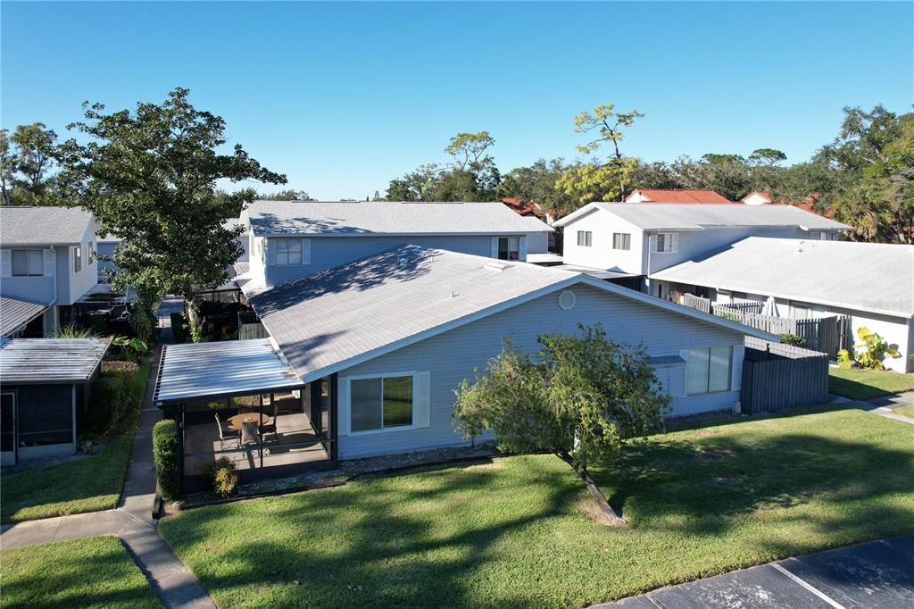 a view of a house with a backyard and a patio