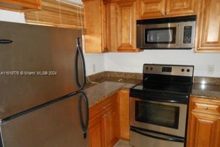 a kitchen with granite countertop cabinets washer and dryer