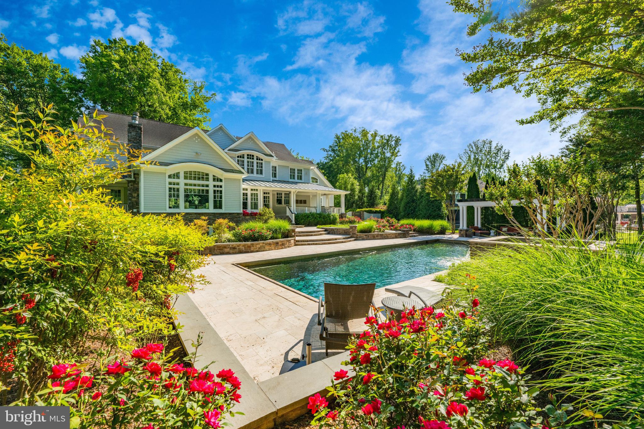 a view of a house with a big yard and potted plants