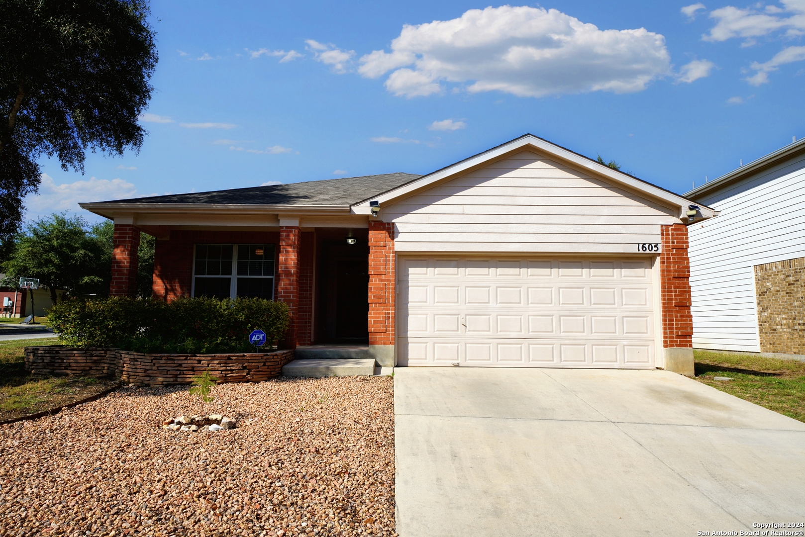 a view of house with outdoor space and a yard