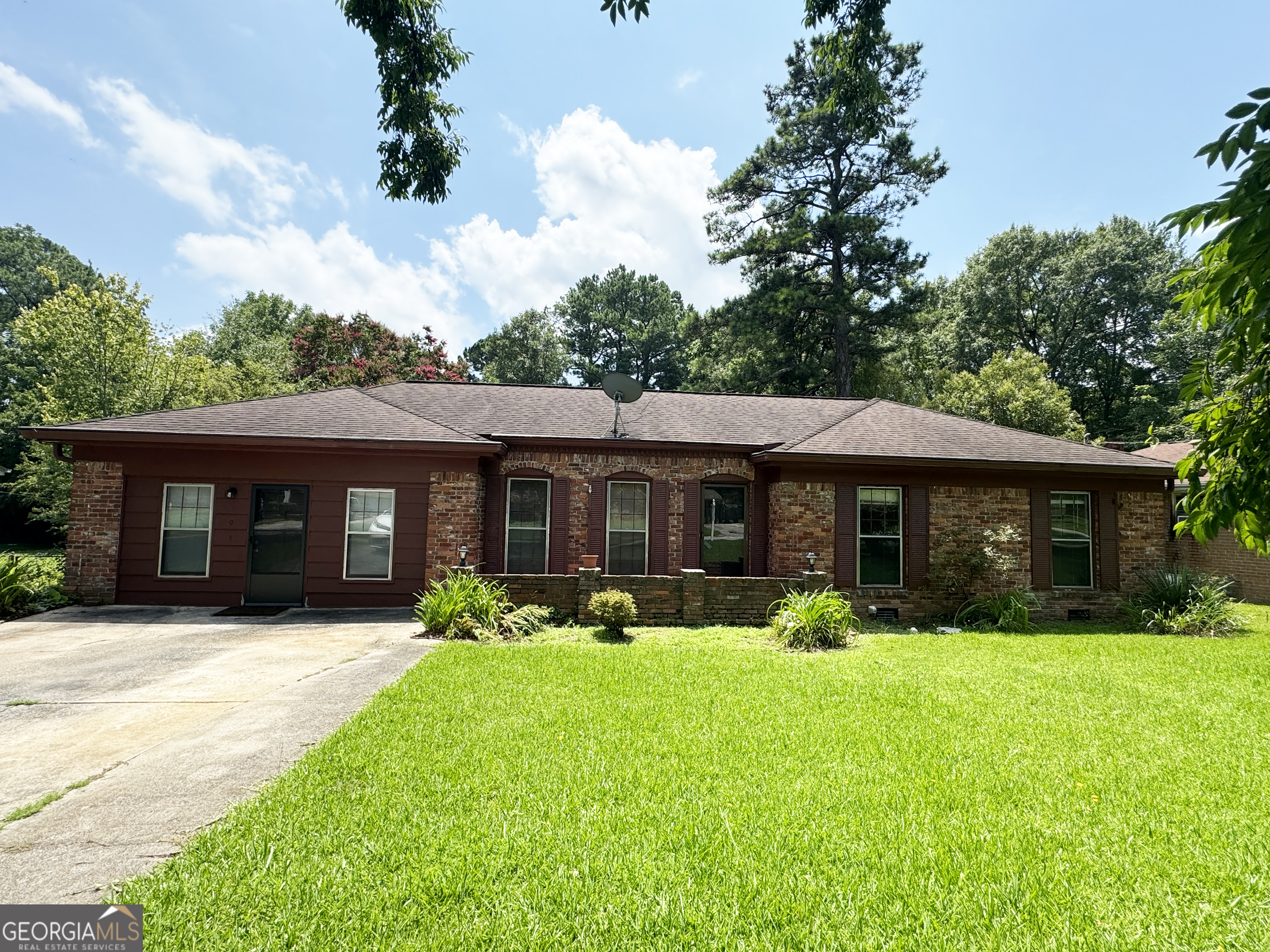 a front view of house with yard and green space