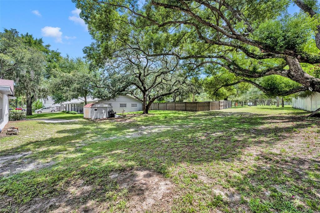 a backyard of a house with lots of green space and fountain