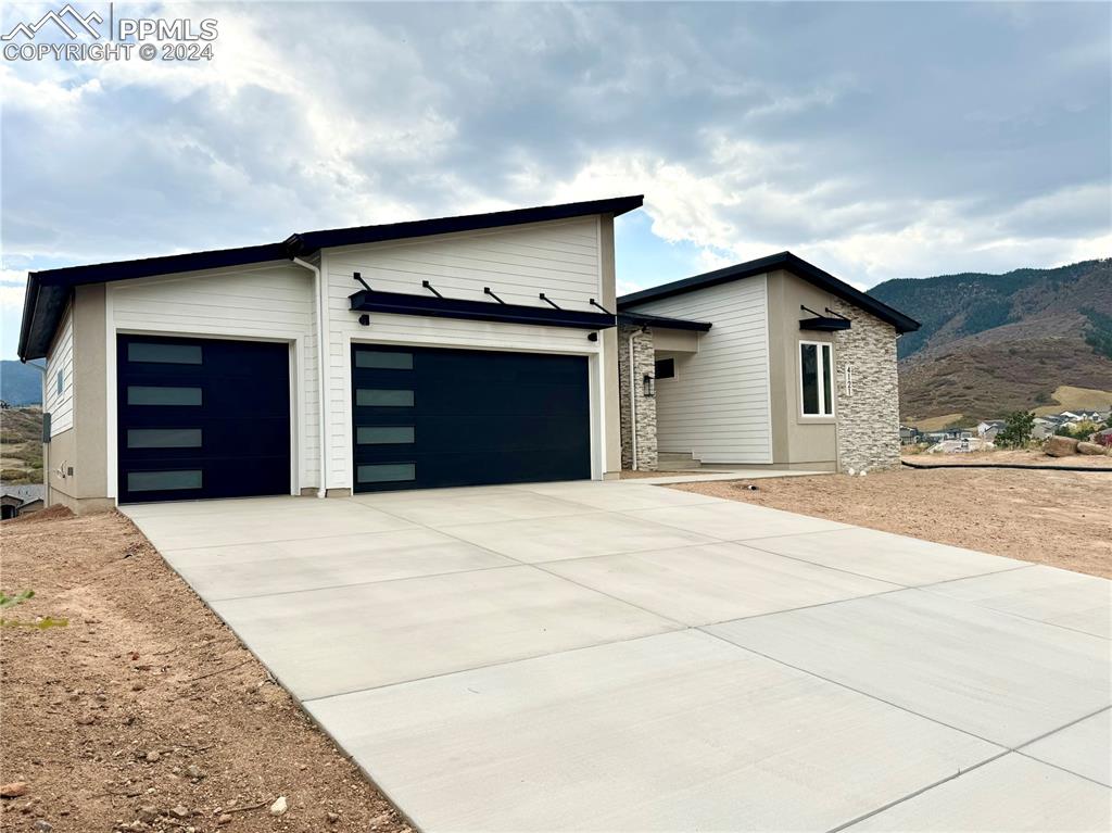 Contemporary house featuring a mountain view and a garage