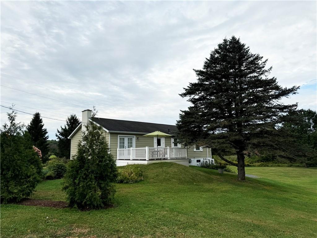 a front view of a house with a garden