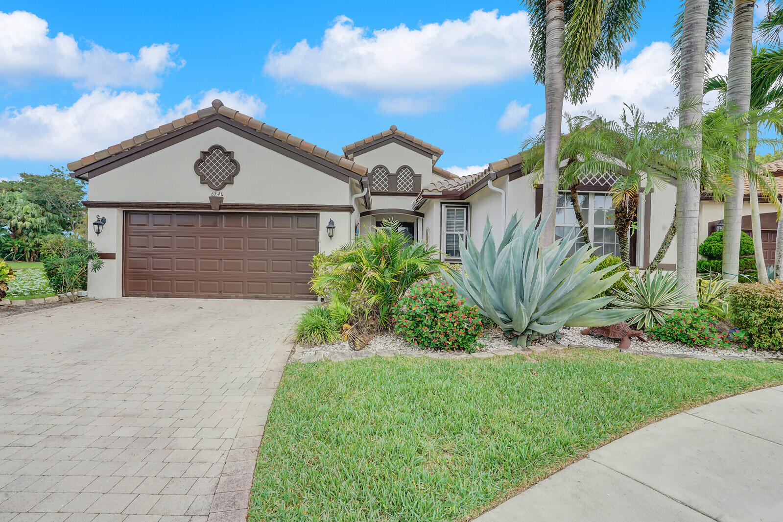 a view of a front of house with a yard and garage