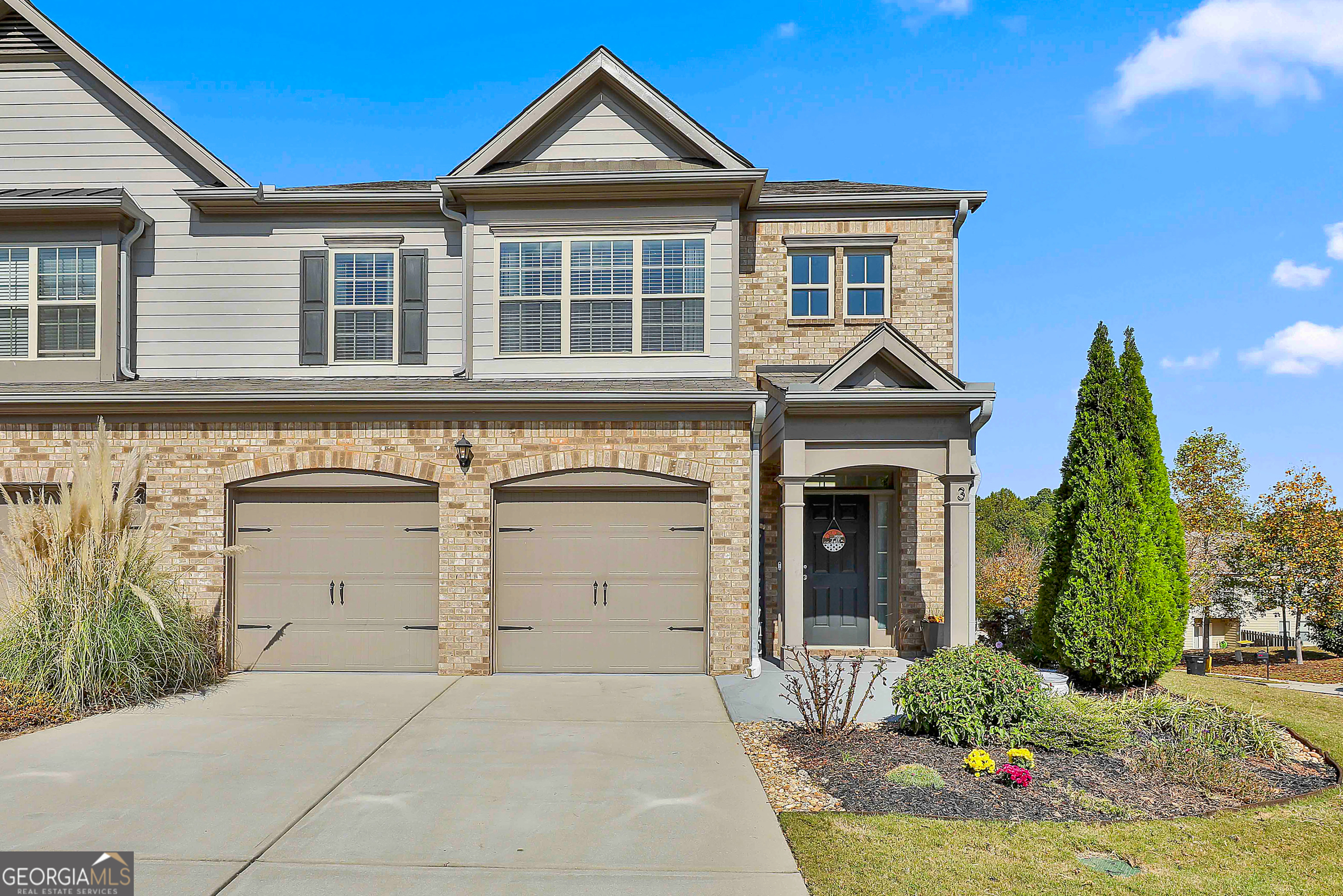 a front view of a house with a yard and garage