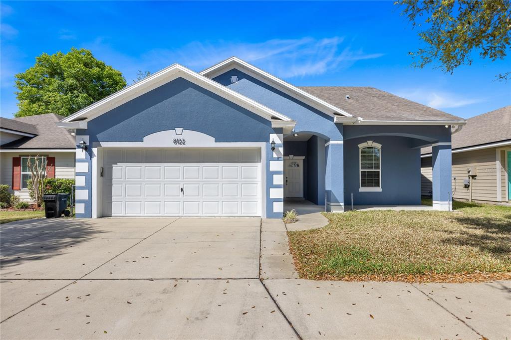 a front view of a house with a yard and garage