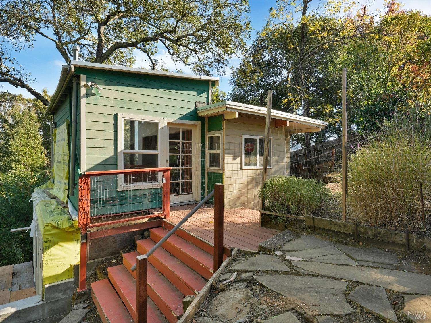 a view of a house with backyard and chairs