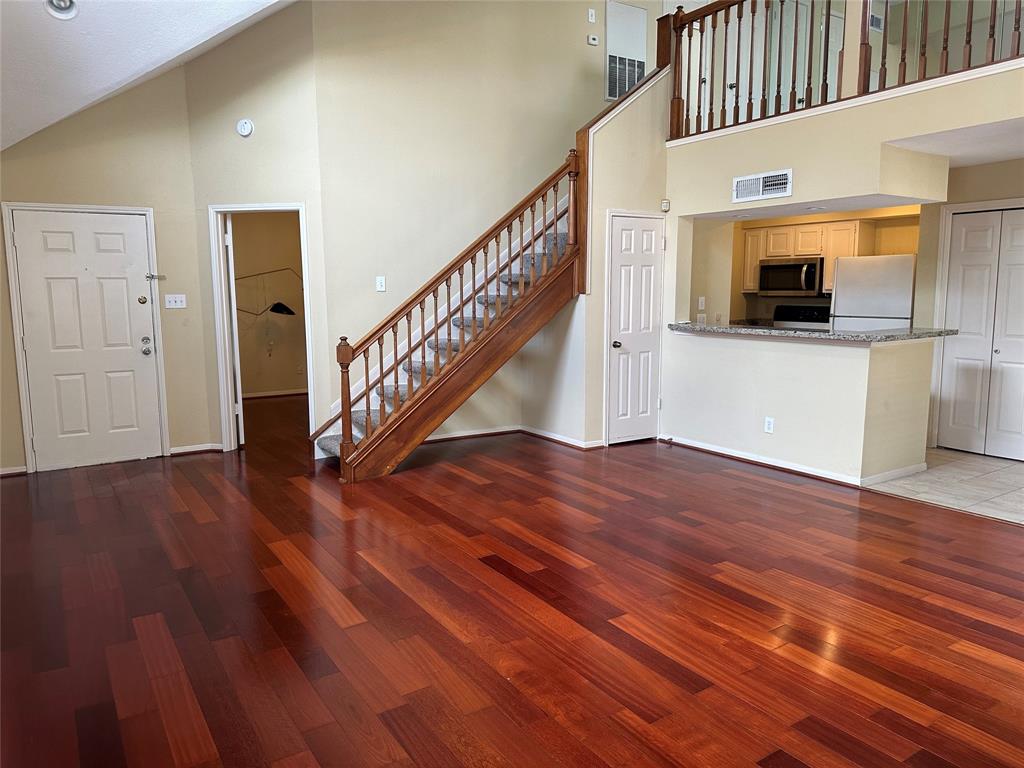 a view of entryway and hall with wooden floor