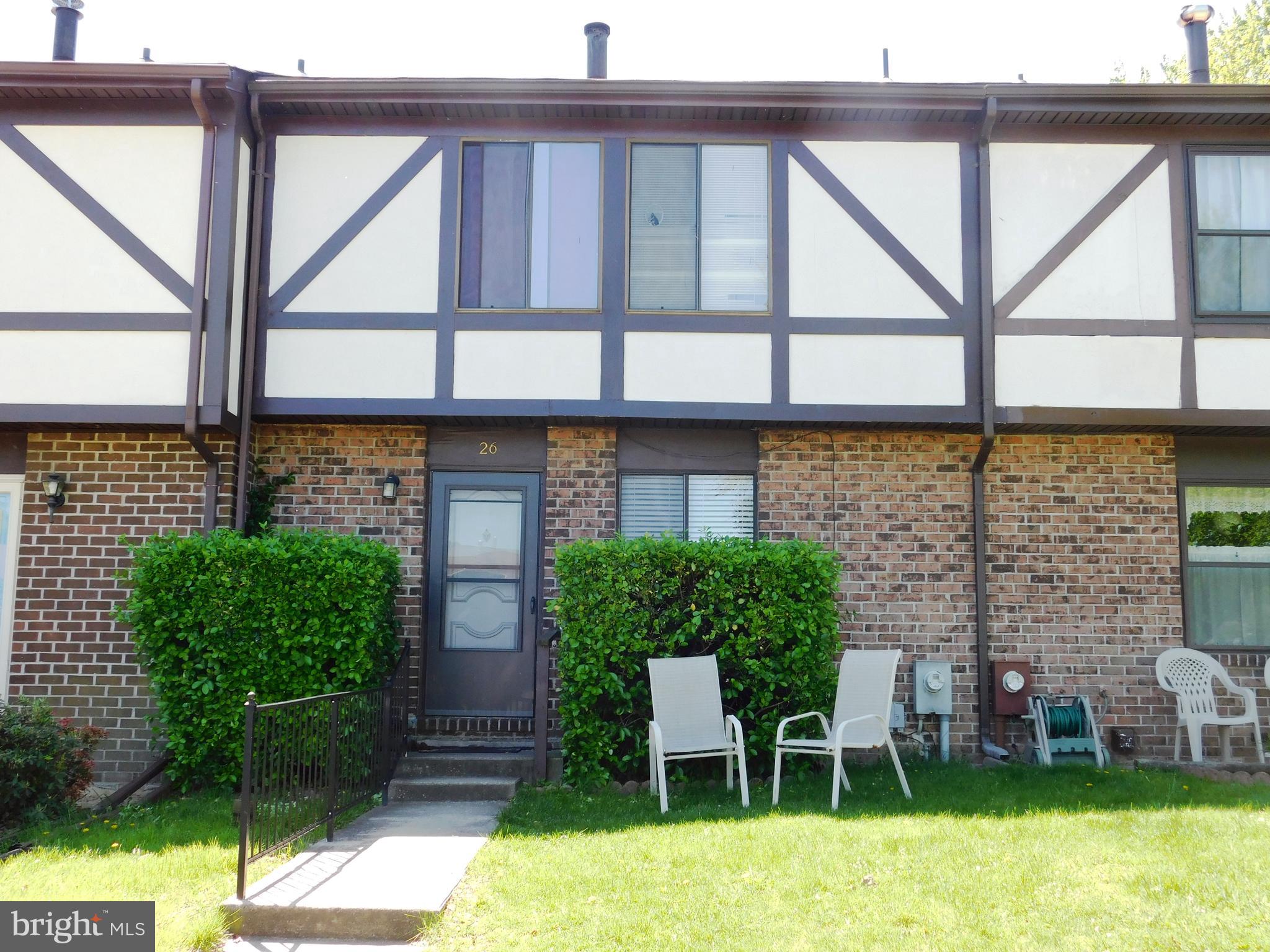 a view of front door and small yard