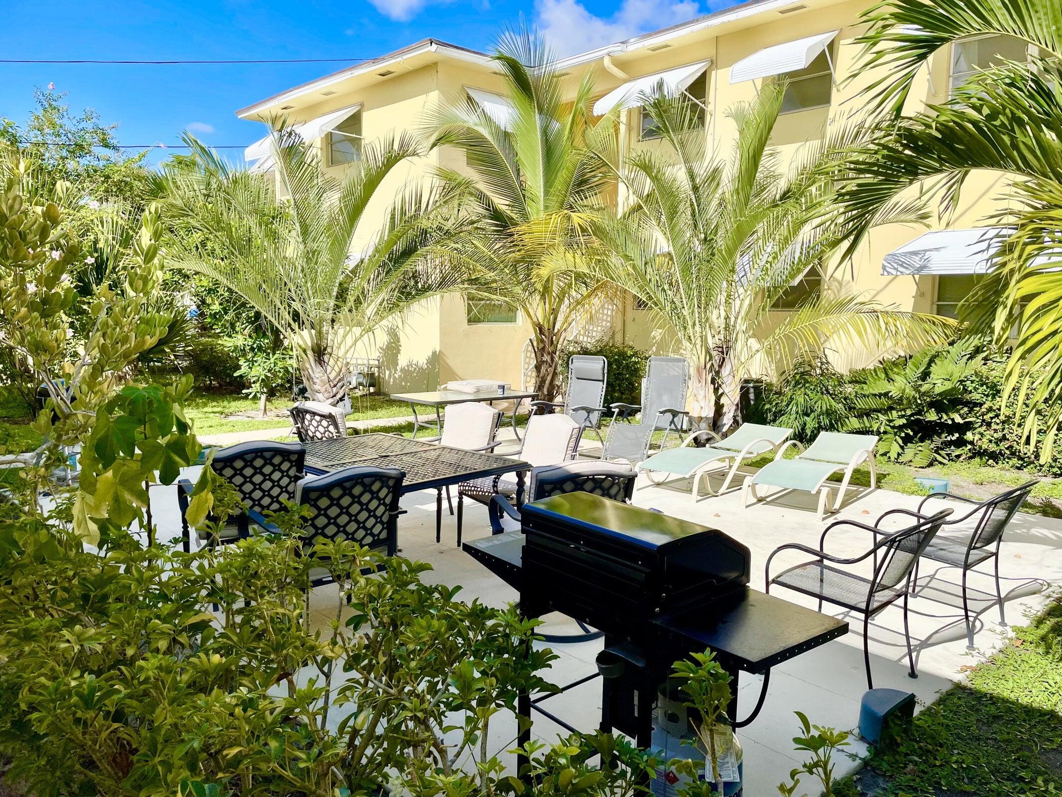 a view of a patio with table and chairs and potted plants