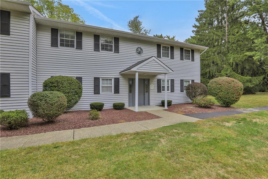 Colonial home with a front yard