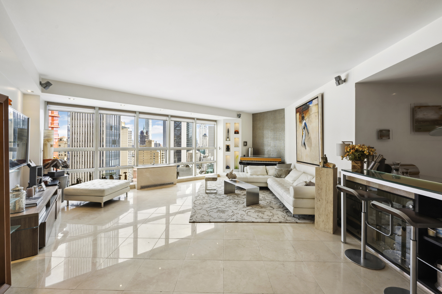 a living room with furniture large window and glass door