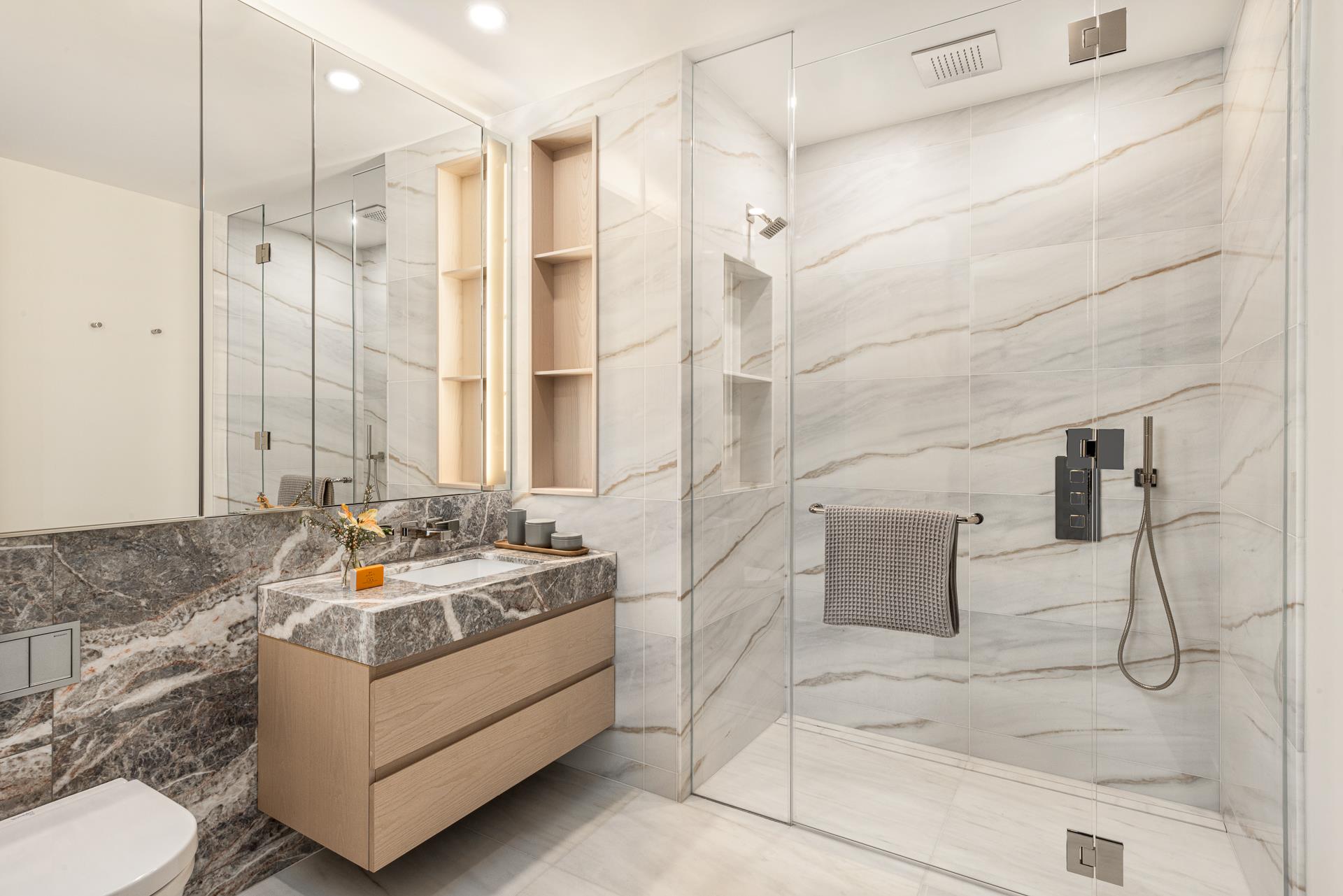 a bathroom with sink mirror and shower