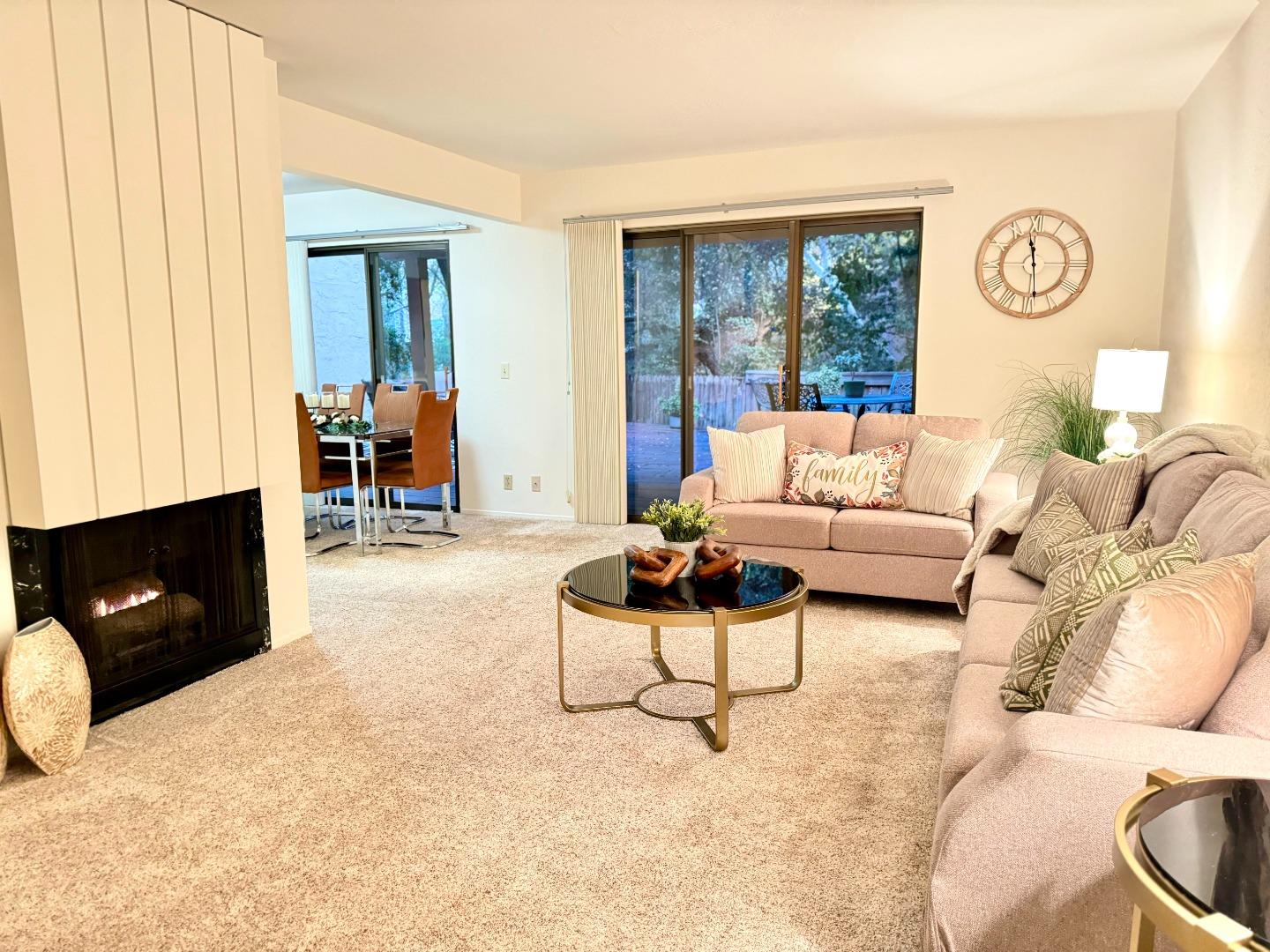 a living room with furniture a flat screen tv and a window