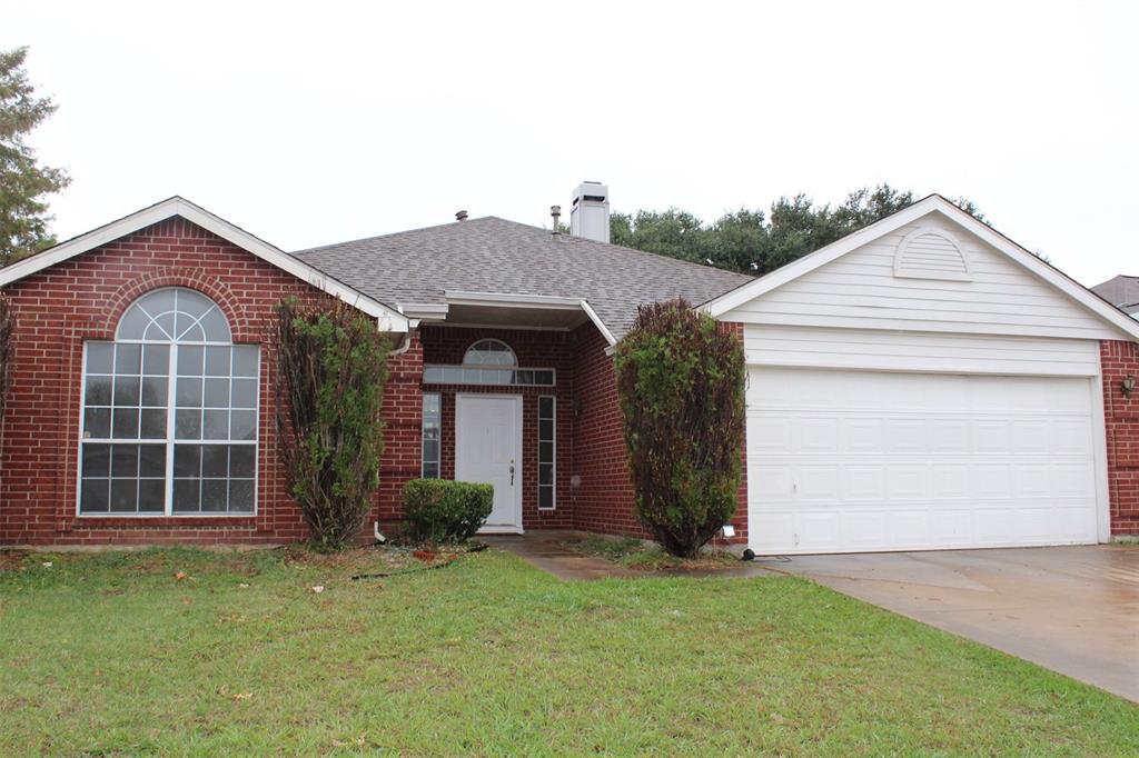 a front view of a house with a garden and garage