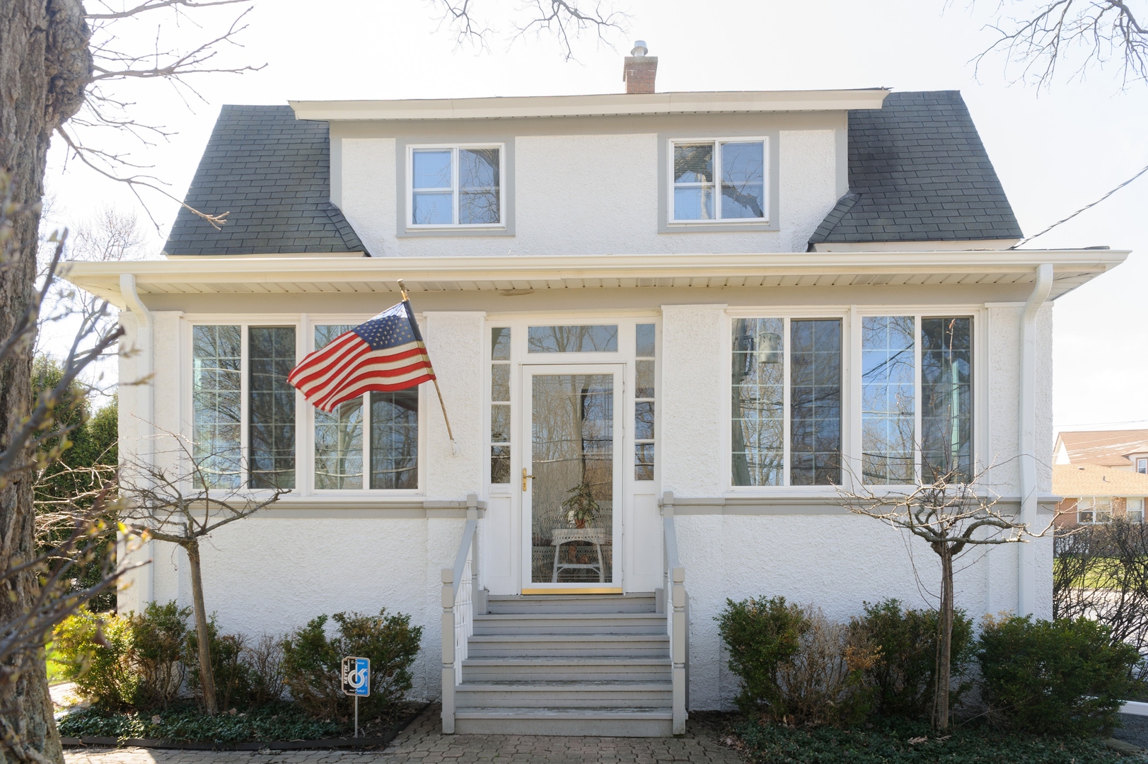 a front view of a house with a garden