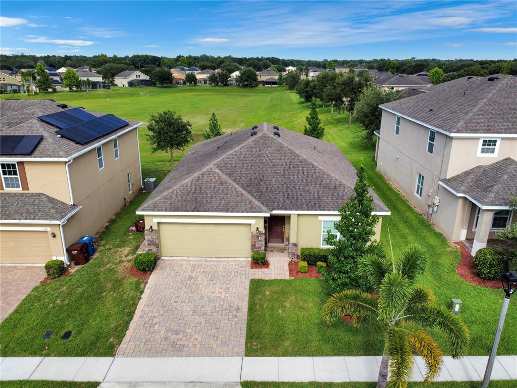 an aerial view of a house with outdoor space and street view