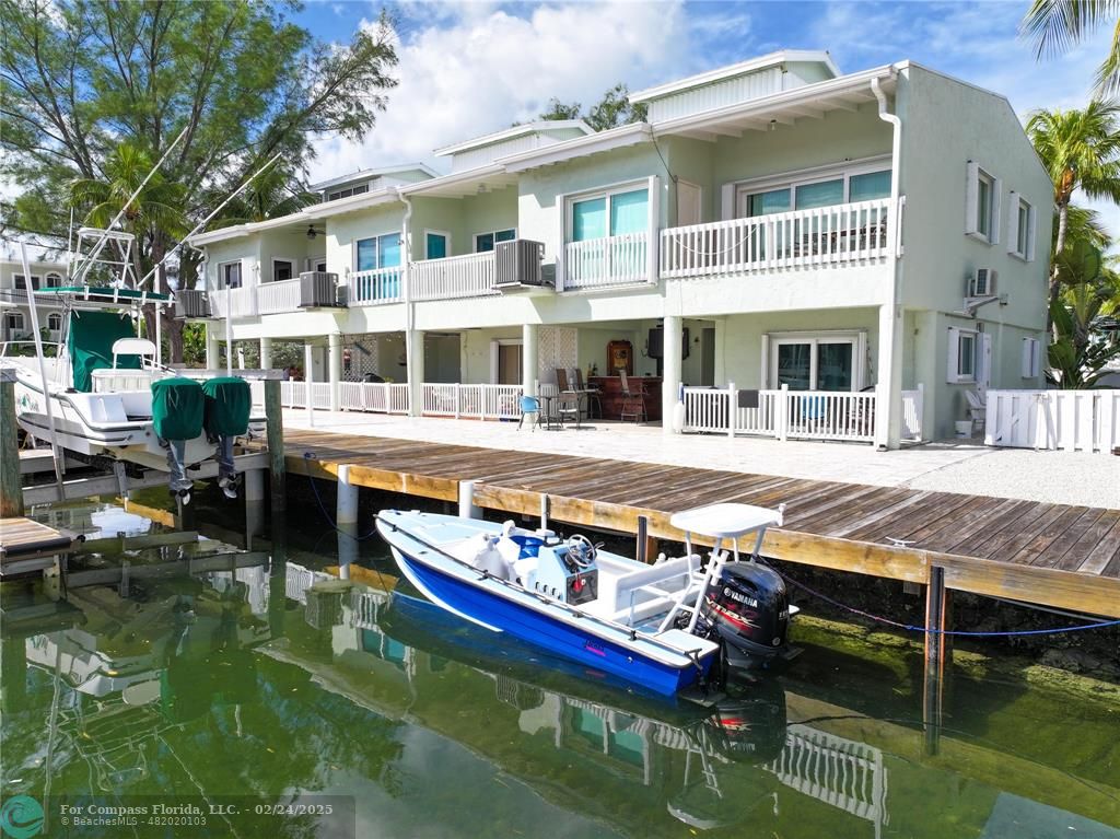 a view of house with swimming pool and chairs