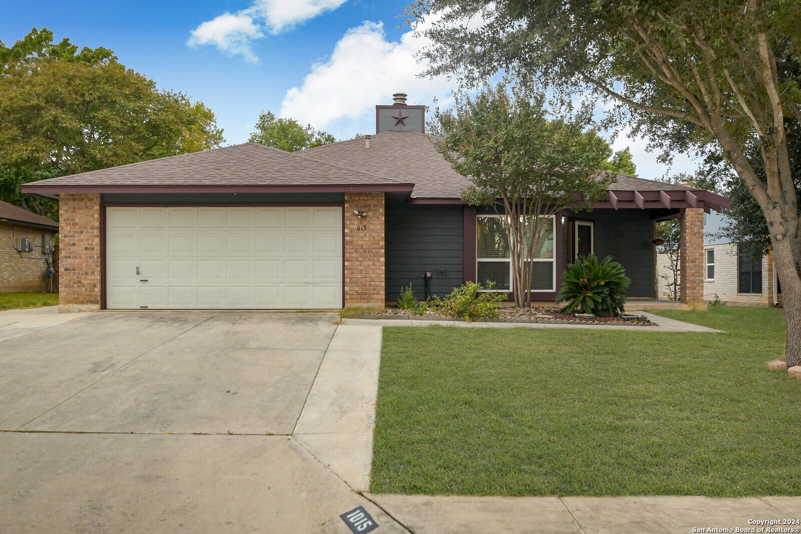 a front view of house with yard and trees