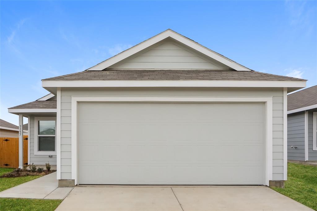 a front view of a house with garage