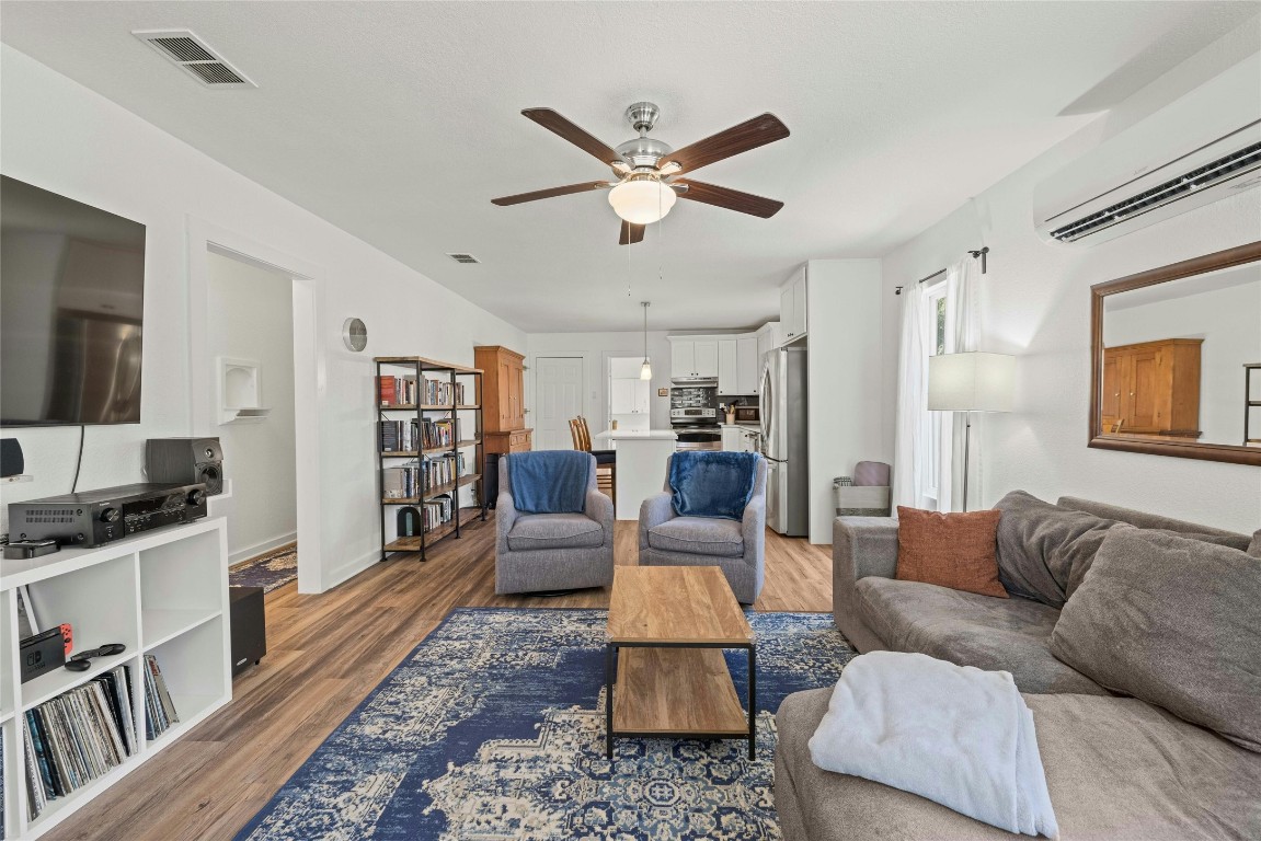 a living room with furniture and view of kitchen