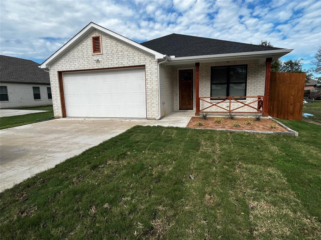 a front view of a house with a yard and garage