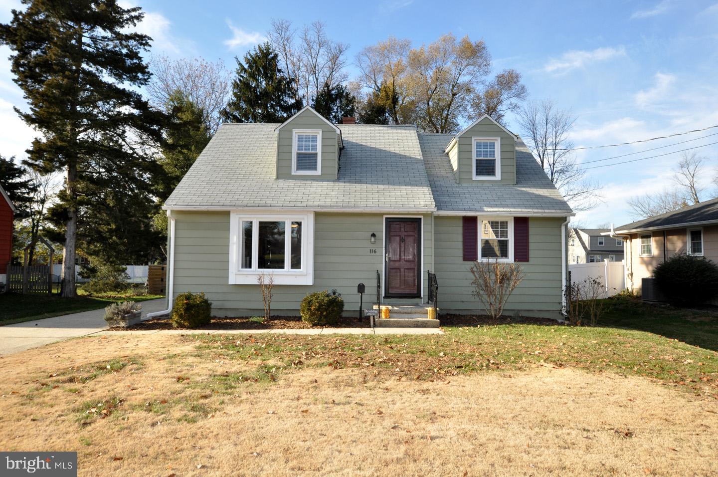 a front view of a house with a yard covered in snow