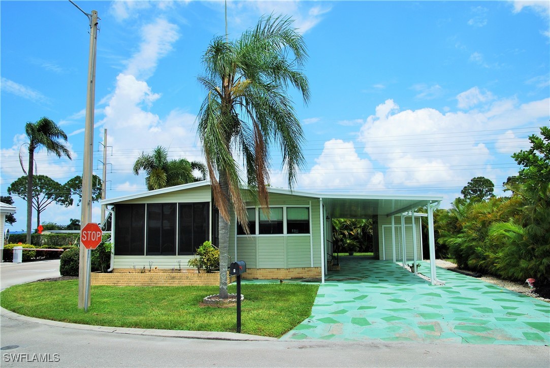 a front view of a house with a garden and yard