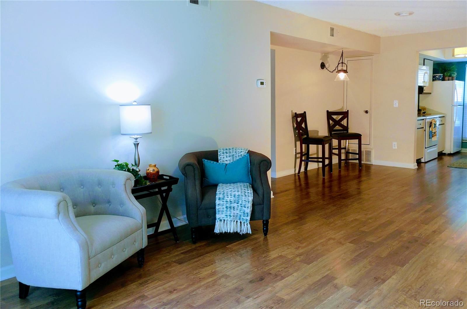 a living room with furniture and wooden floor