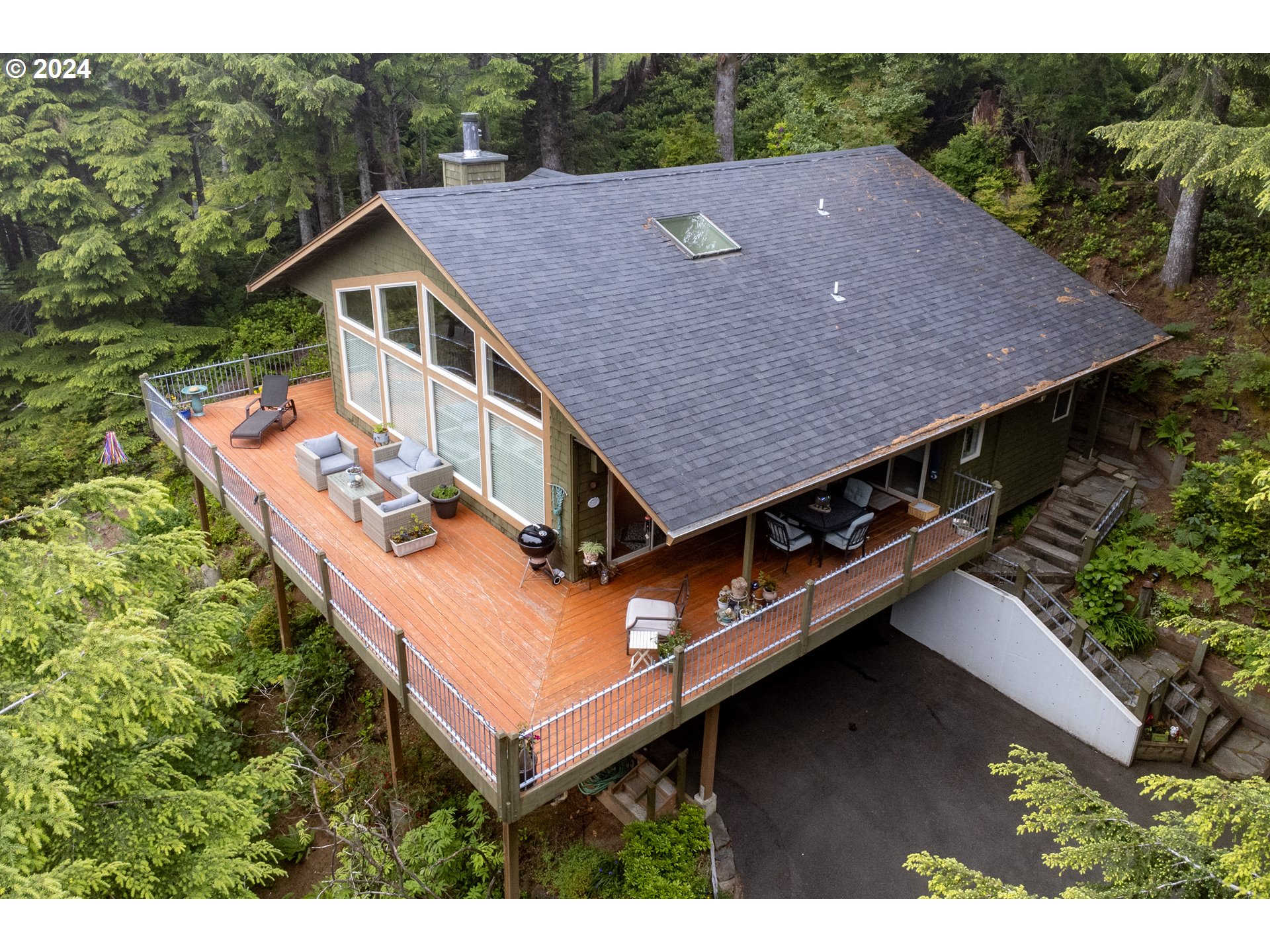 a aerial view of a house with a yard balcony and mountain view