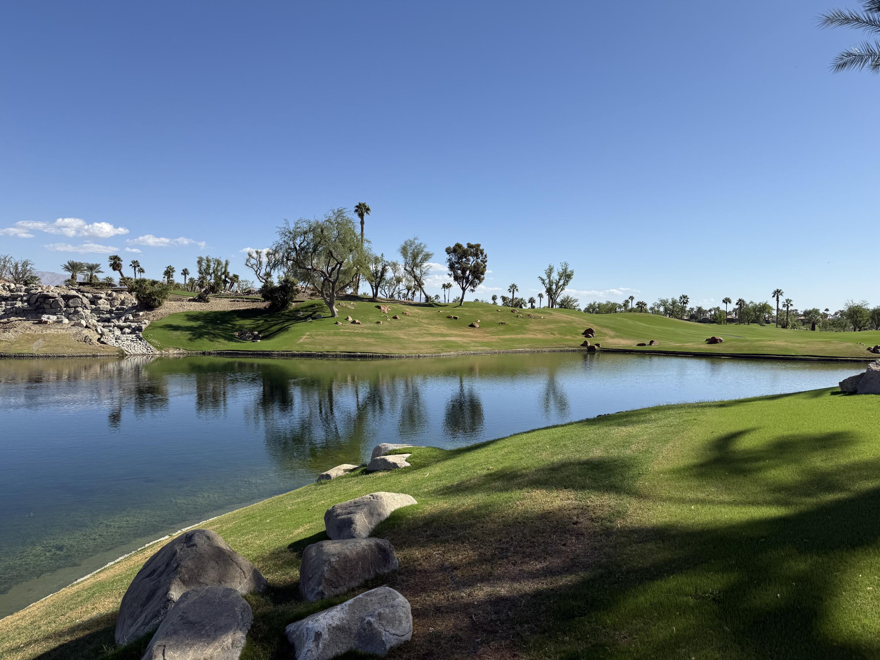 a view of a lake with a house swimming pool and outdoor space