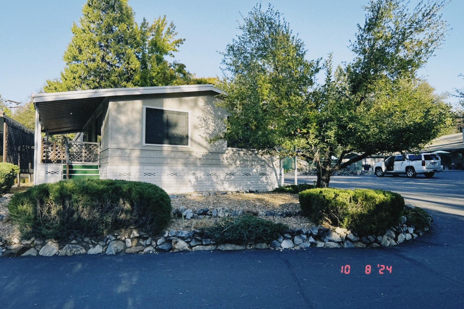 a view of a house with yard and sitting area