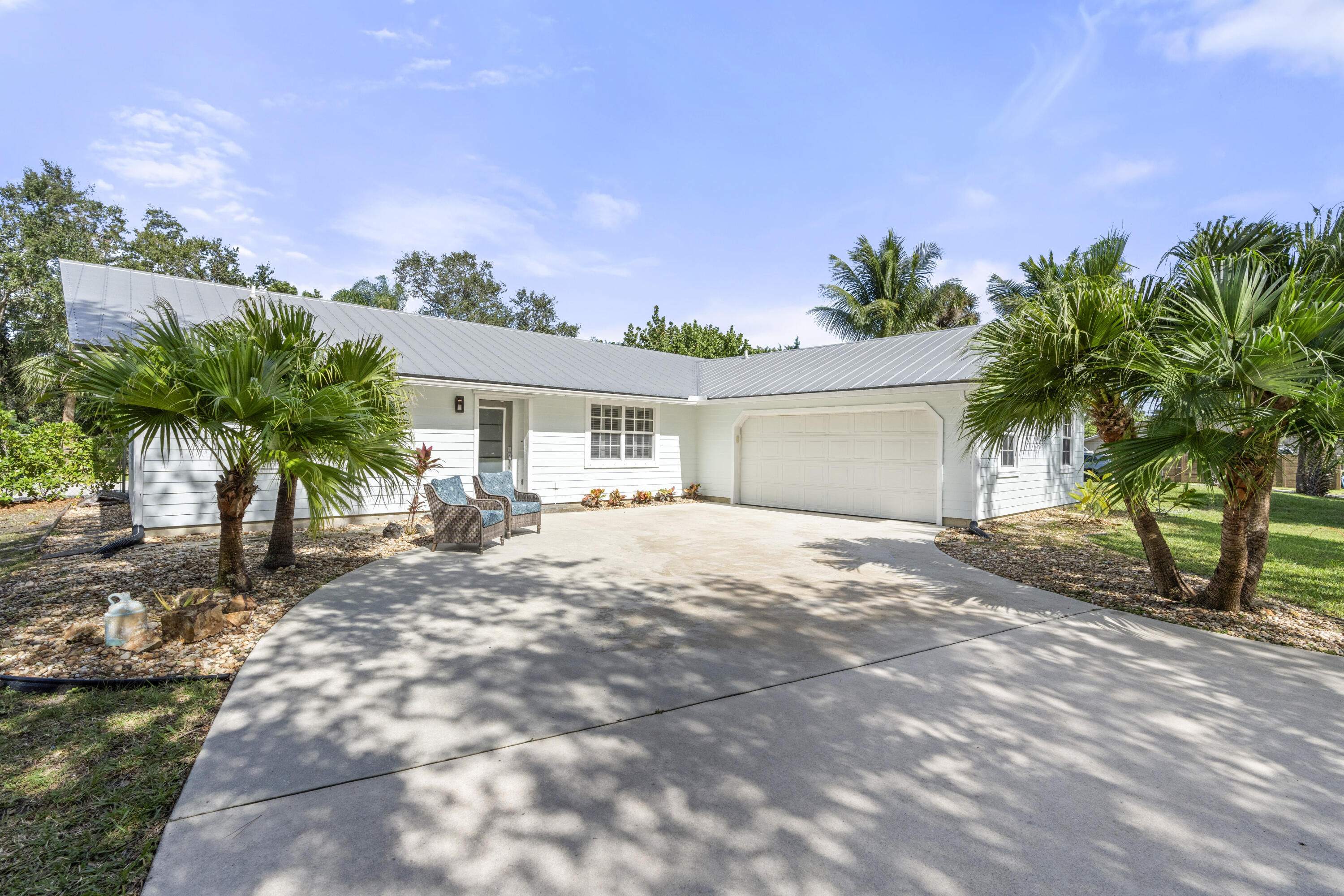 a front view of a house with a yard and a garage