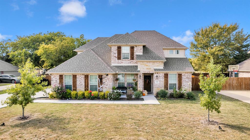 a front view of a house with a yard