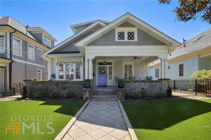 a front view of a house with a yard and outdoor seating