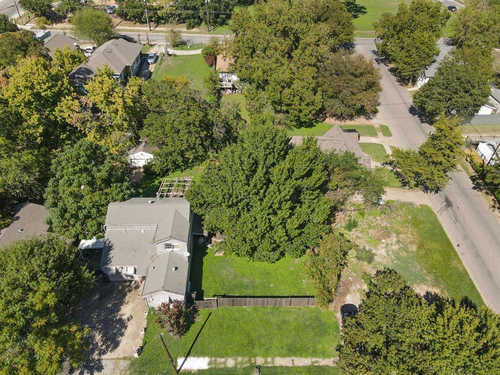 an aerial view of residential house with outdoor space and trees all around