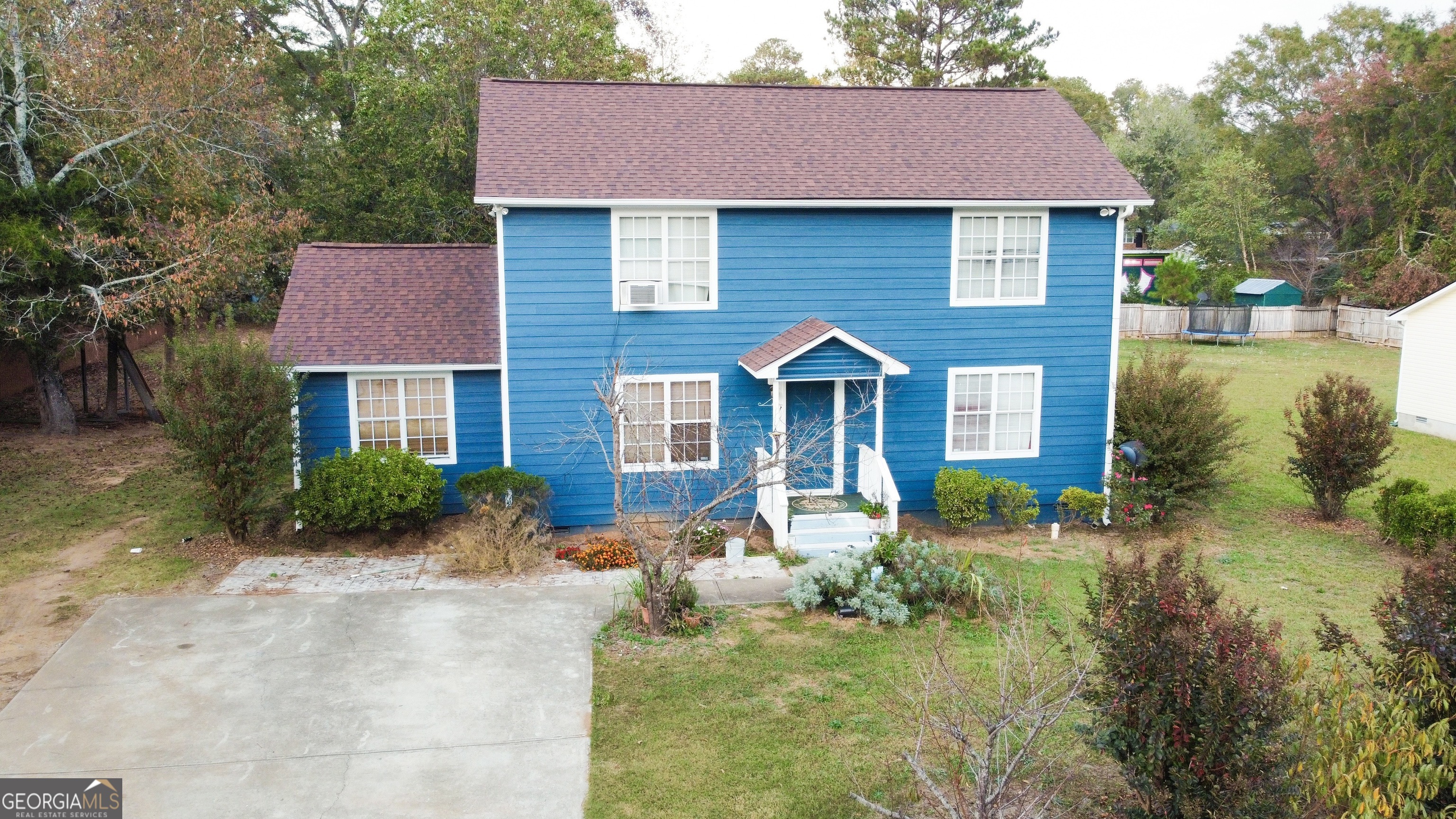 a front view of a house with garden