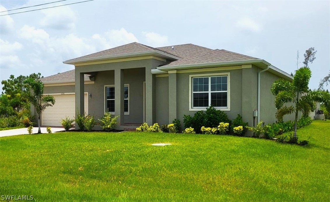 a front view of a house with a garden