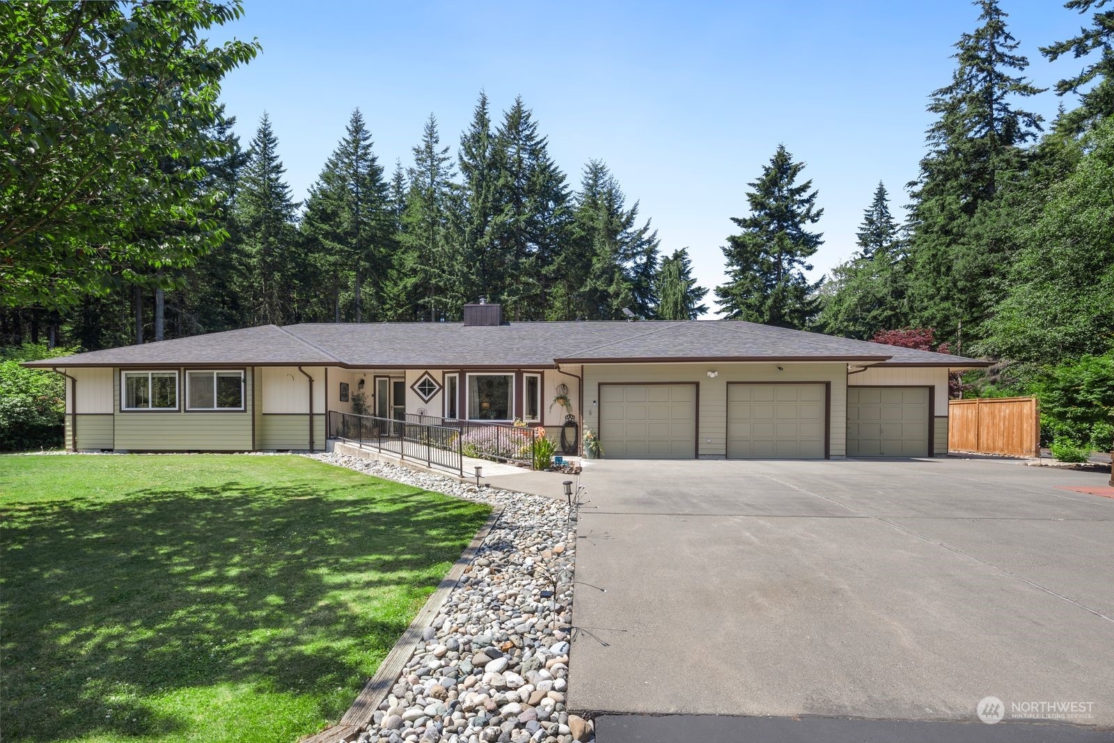 a front view of a house with yard and green space