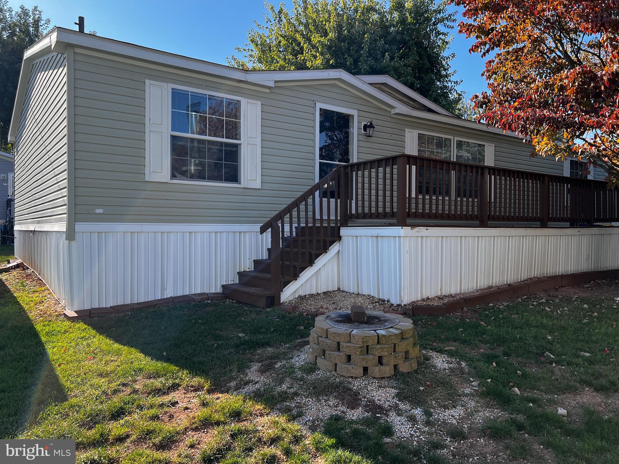 a view of a house with backyard and wooden fence