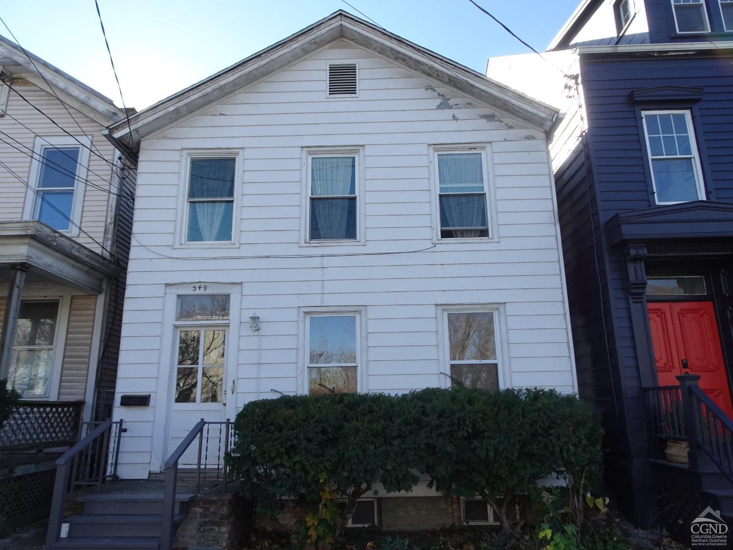 a view of a house with many windows and a yard