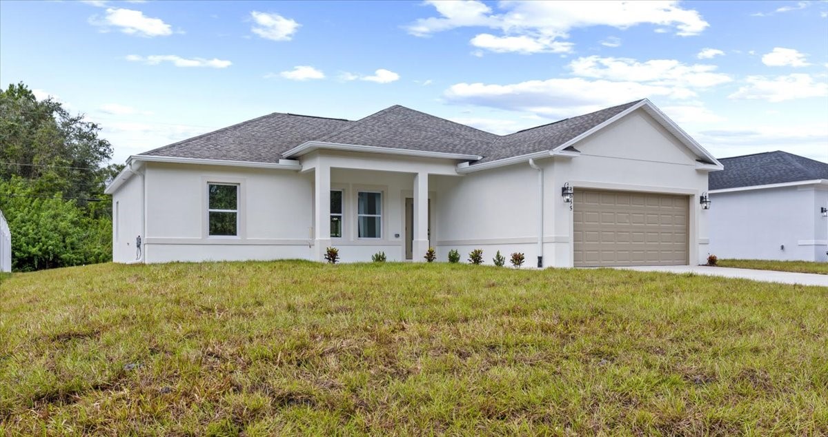 a front view of house with yard and trees