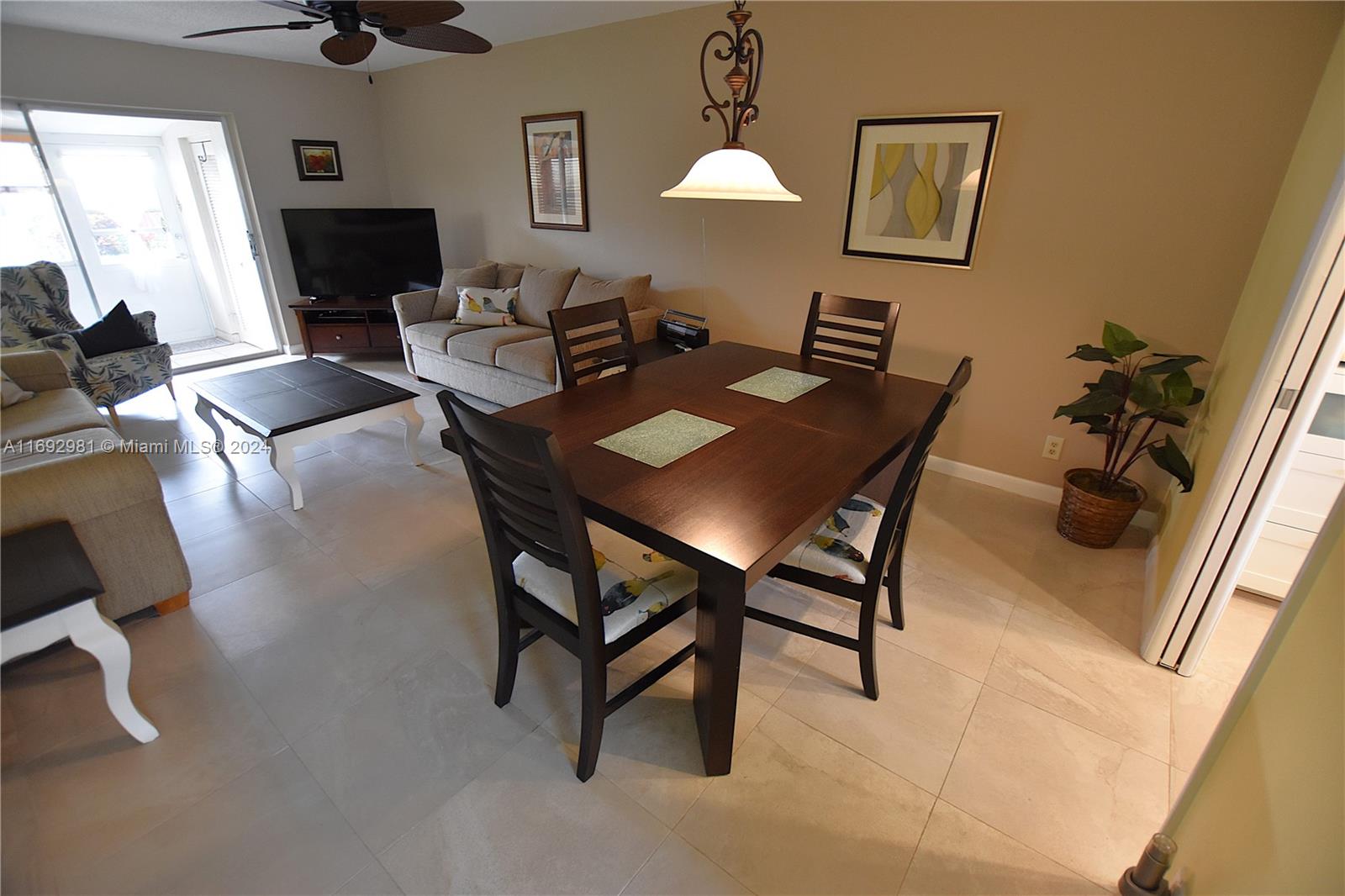 a view of a dining room with furniture and a mirror