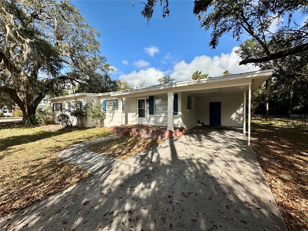 a view of a house with a yard and tree s