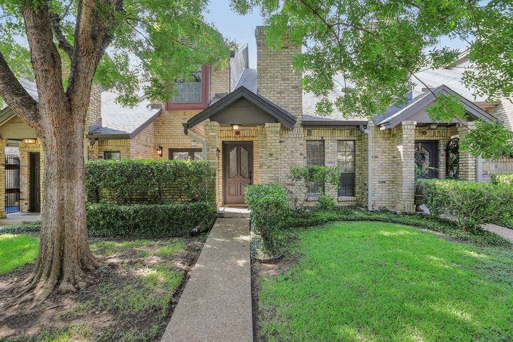 a front view of a house with yard and green space