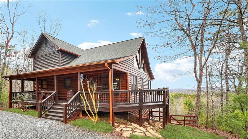 a view of a house with a yard and furniture