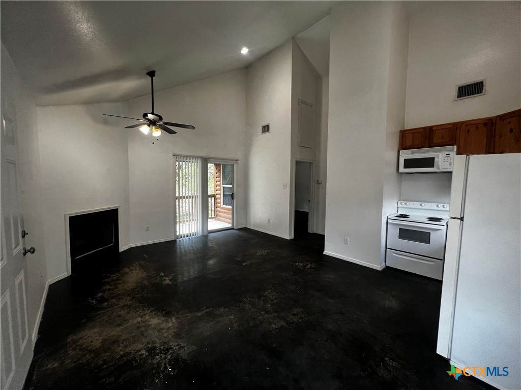 a kitchen with a refrigerator and a stove top oven