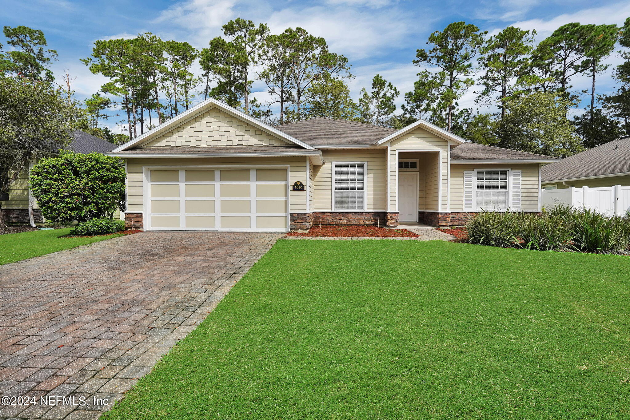 a front view of house with yard and green space