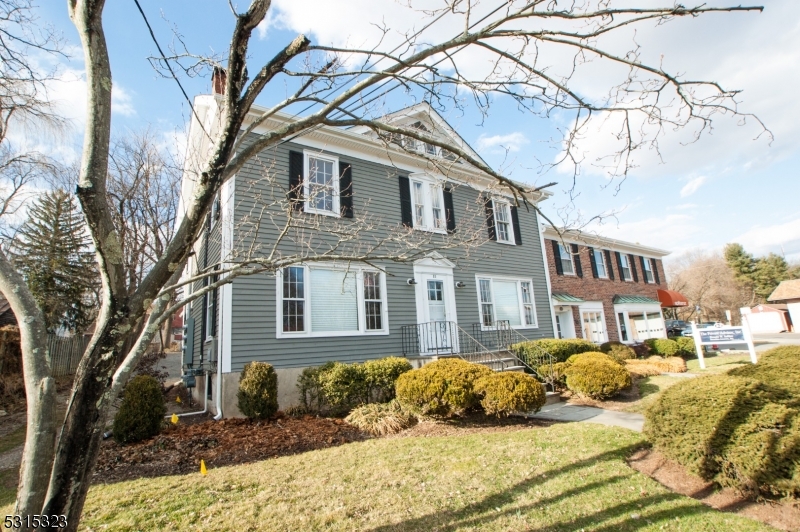 a front view of a house with a yard covered in snow